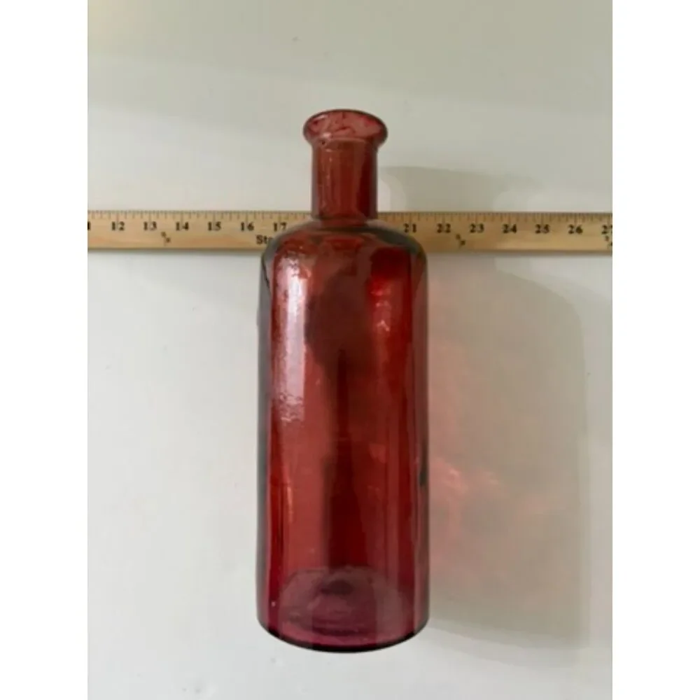 vtg ruby red glass bottle with circular medallion